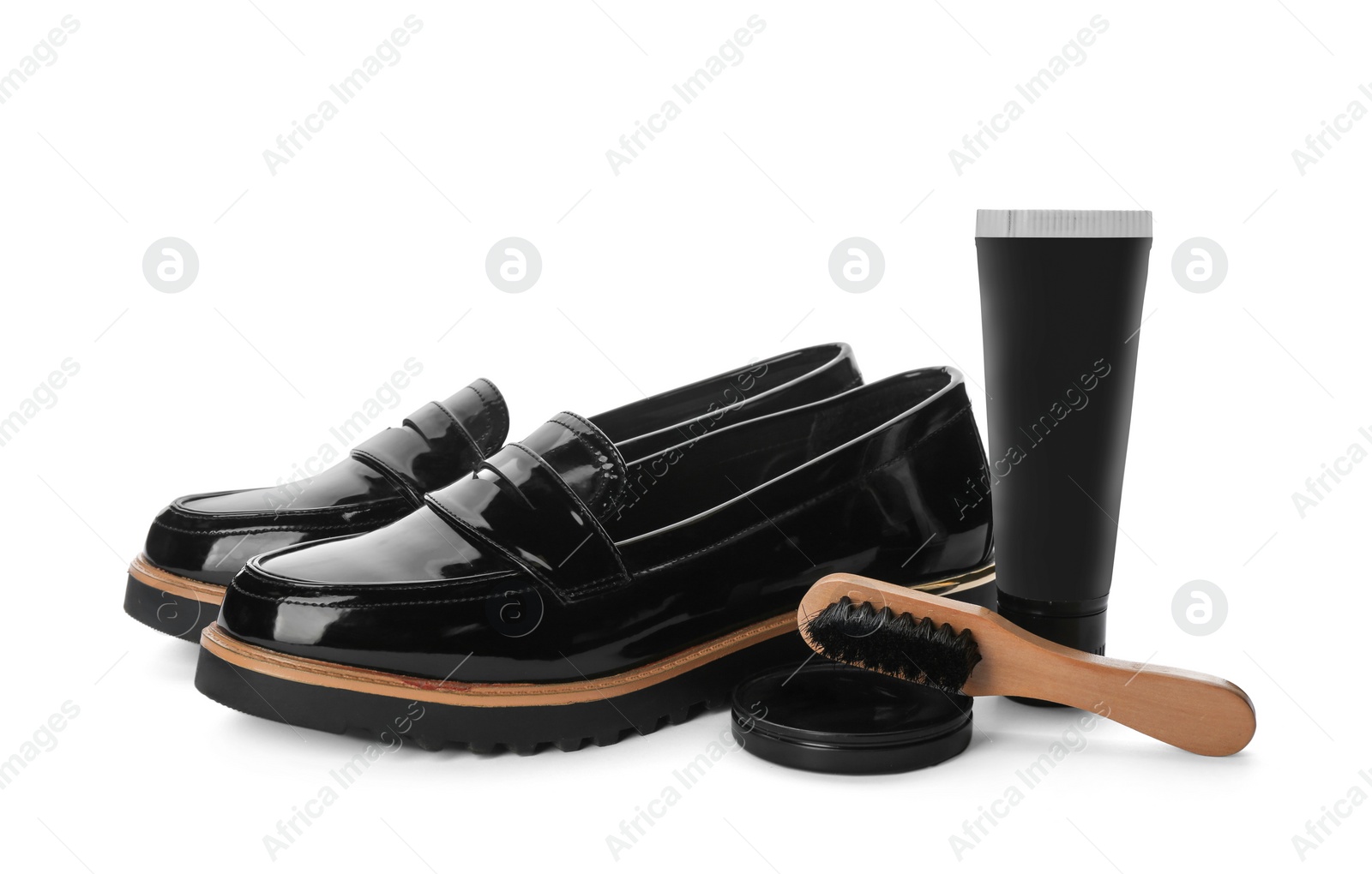 Photo of Stylish footwear and shoe care products on white background