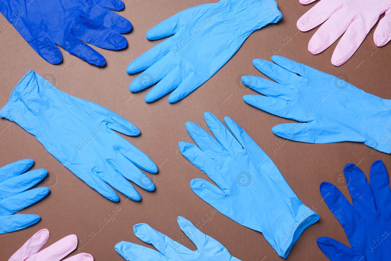 Photo of Flat lay composition with different medical gloves on color background