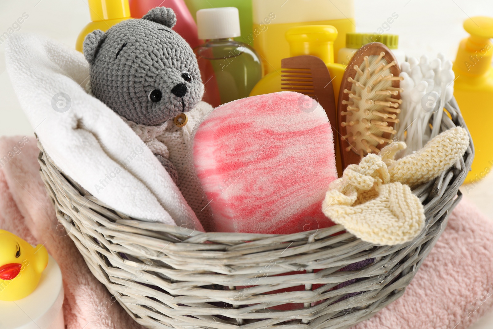 Photo of Wicker basket with baby cosmetics and accessories, closeup view