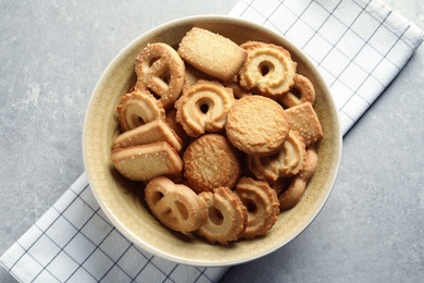 Photo of Bowl with Danish butter cookies on grey background, top view