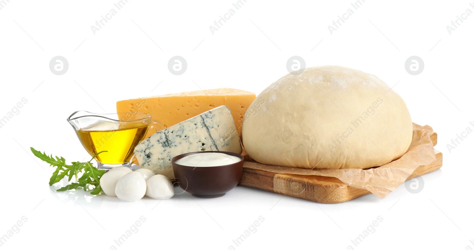 Photo of Fresh dough and ingredients for pizza on white background