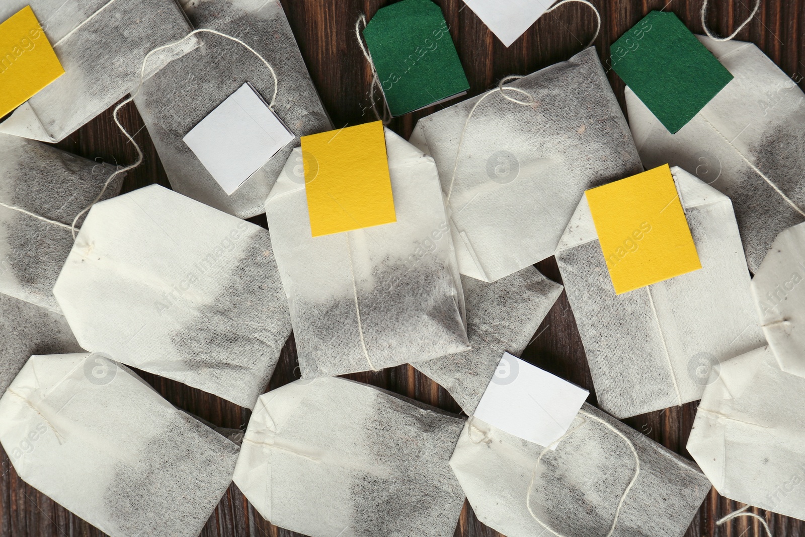 Photo of Tea bags on wooden table, flat lay