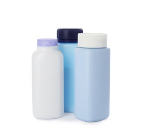 Photo of Bottles of dusting powder on white background, space for design. Baby cosmetic product