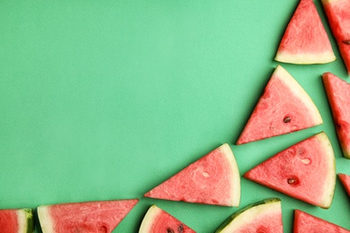 Photo of Slices of ripe watermelon on green background, flat lay. Space for text