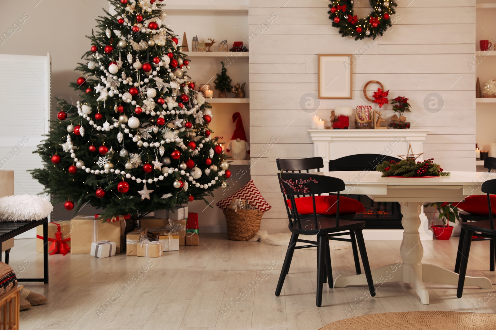 Photo of Cozy dining room interior with Christmas tree and festive decor