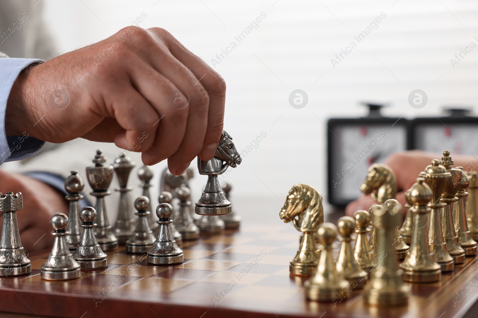 Photo of Man playing chess during tournament at chessboard, closeup