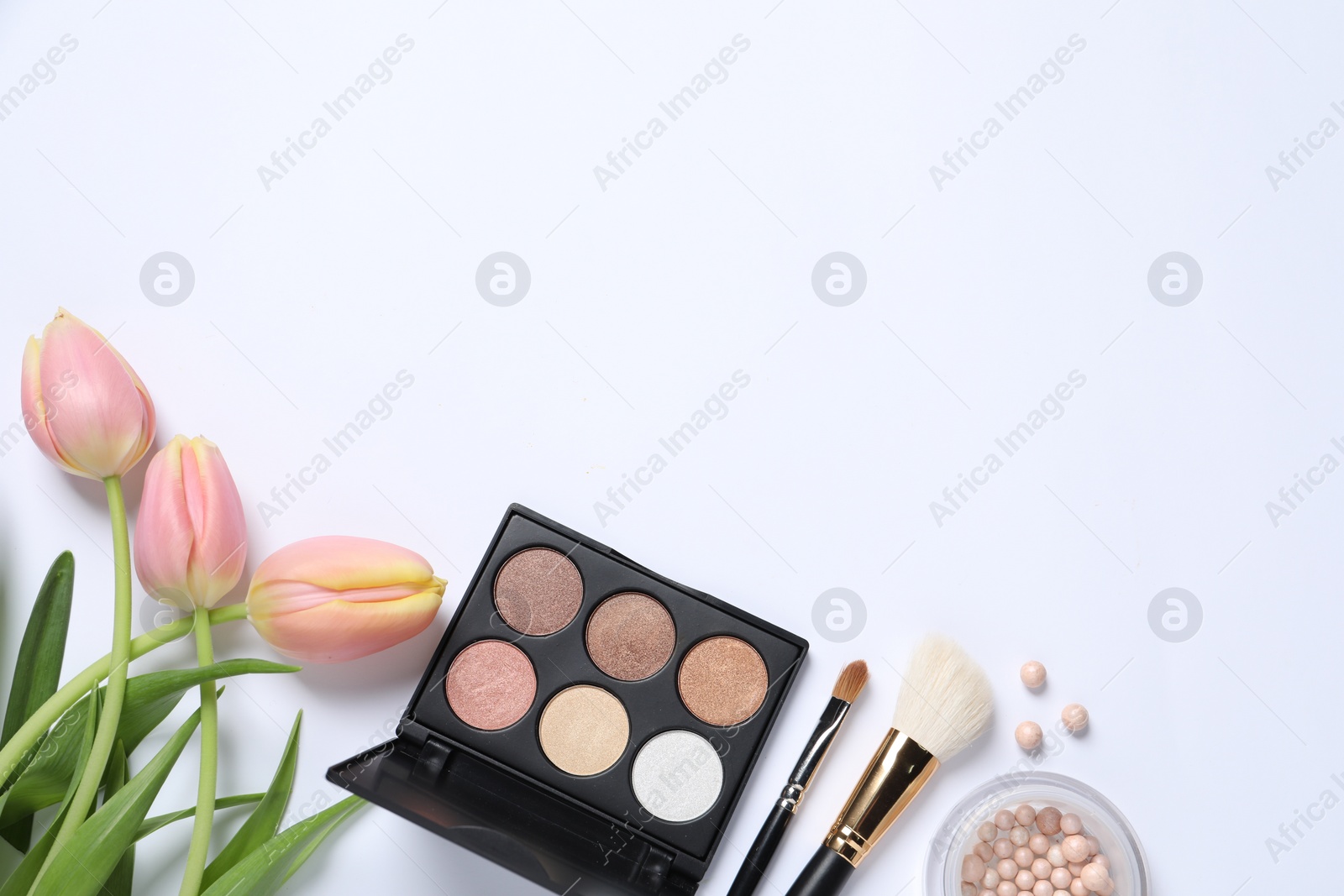 Photo of Flat lay composition with makeup products and beautiful tulips on white background. Space for text