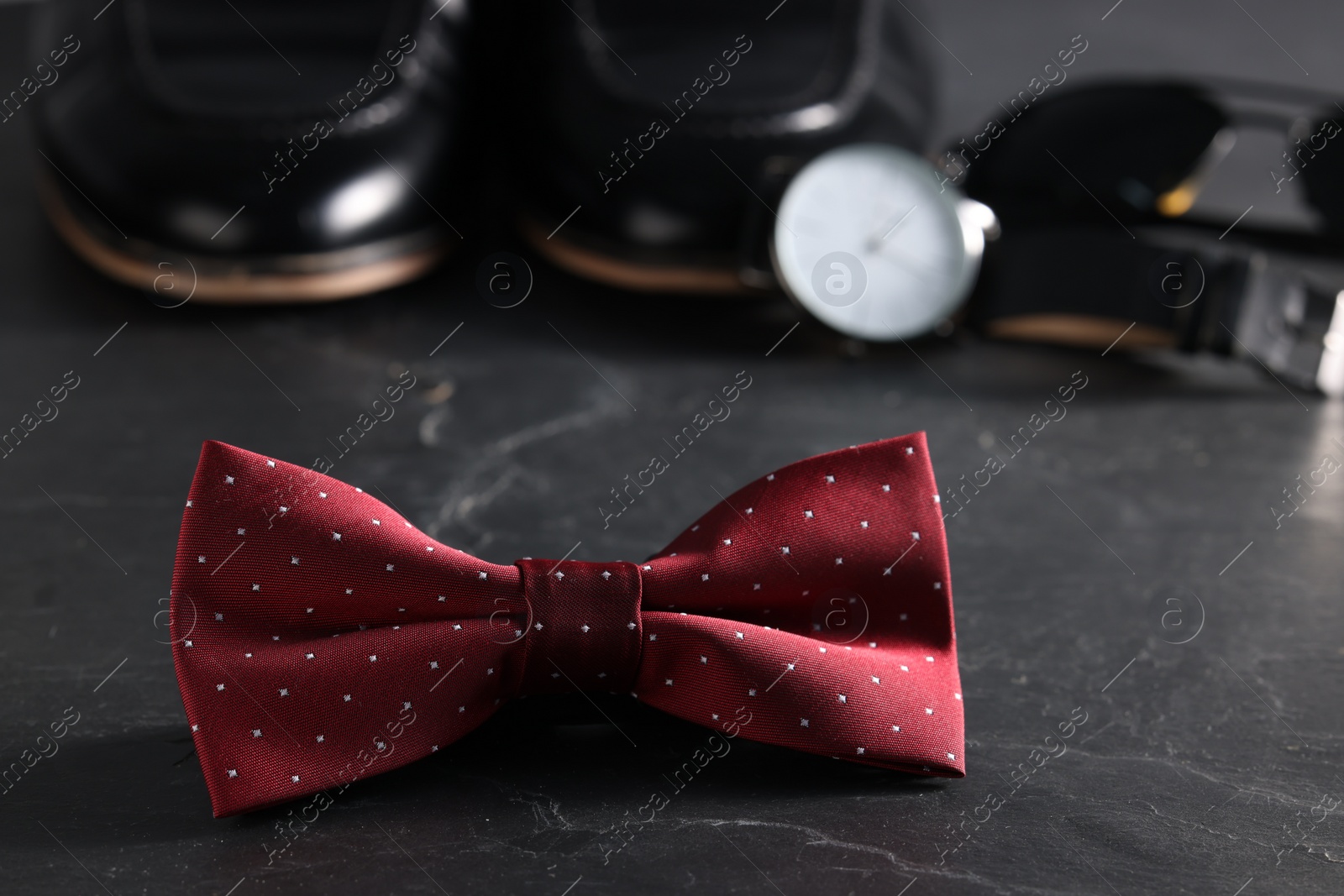 Photo of Stylish red bow tie on black background