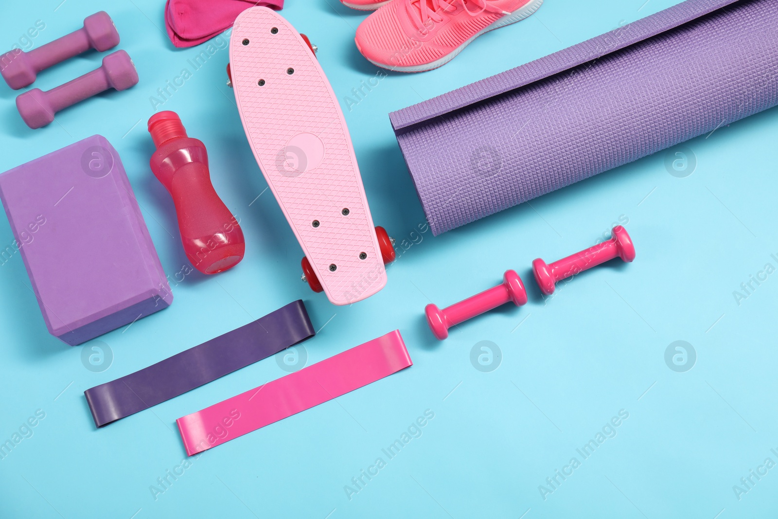 Photo of Different sports equipment on light blue background, flat lay