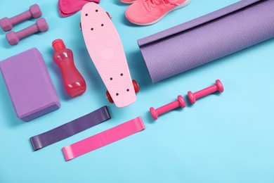 Photo of Different sports equipment on light blue background, flat lay