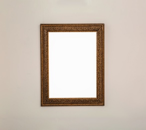 Frame with empty canvas on wall in modern art gallery. Mockup for design