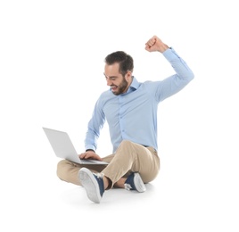 Photo of Emotional young man with laptop celebrating victory on white background