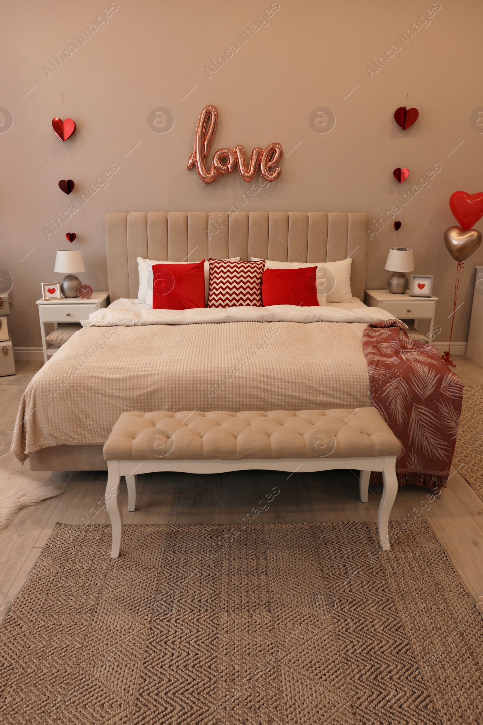 Photo of Cozy bedroom decorated for Valentine Day. Interior design