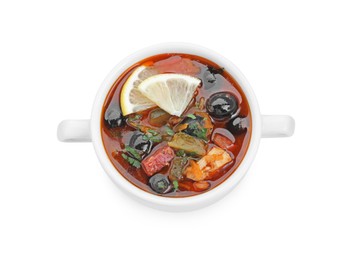 Meat solyanka soup with sausages, olives and vegetables in bowl isolated on white, top view