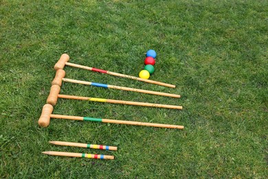 Set of croquet equipment on green grass