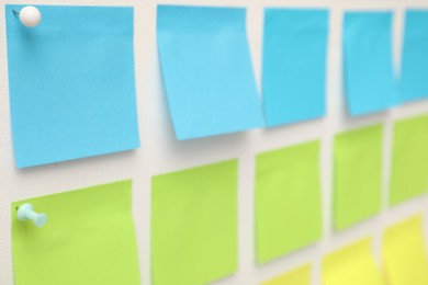Photo of Blank colorful paper notes on white board, closeup