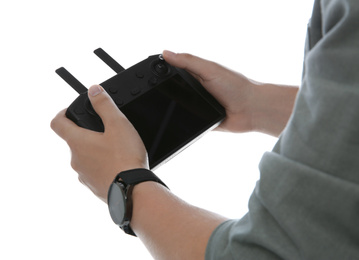 Man holding new modern drone controller on white background, closeup of hands