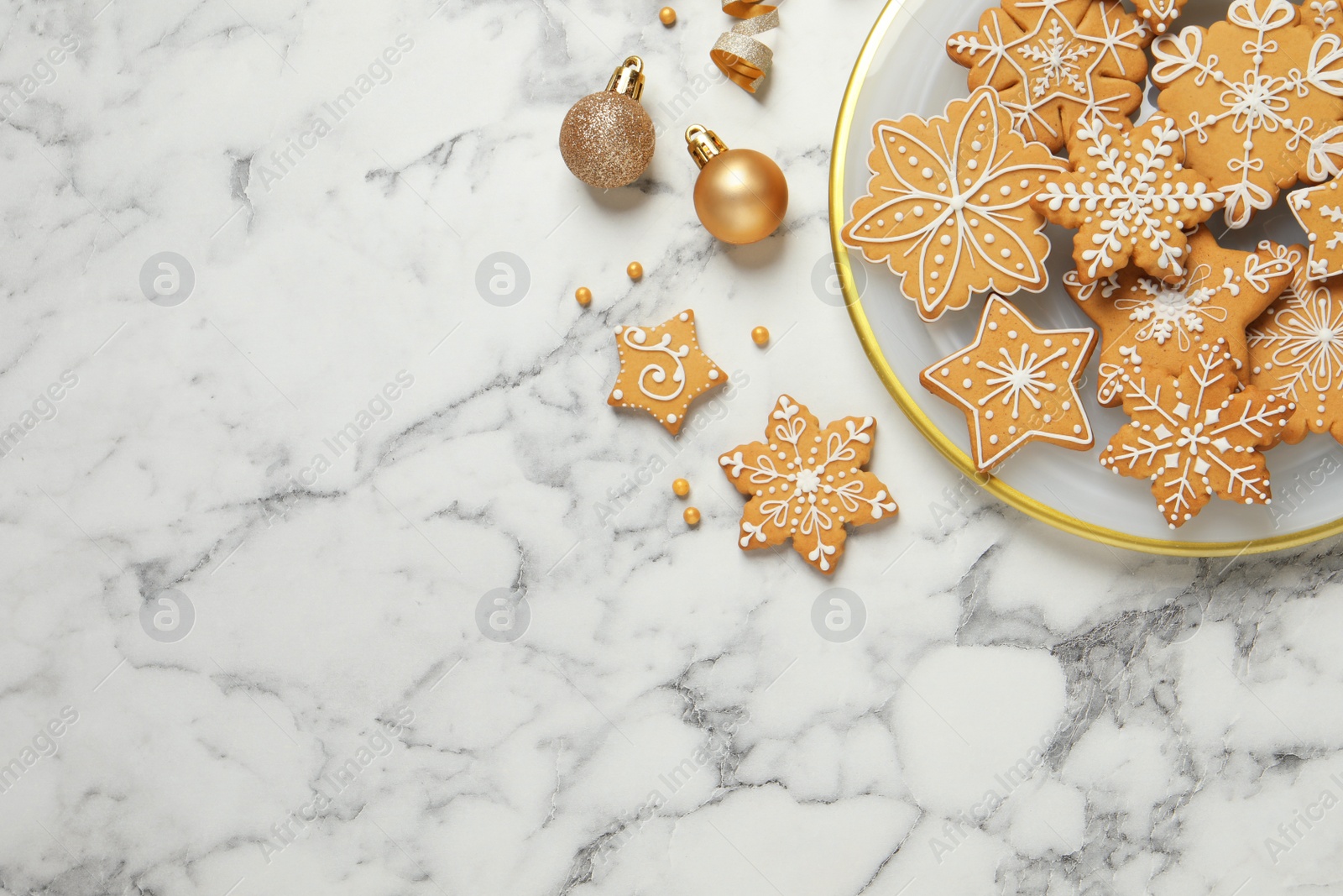 Photo of Tasty Christmas cookies and baubles on white marble table, flat lay. Space for text