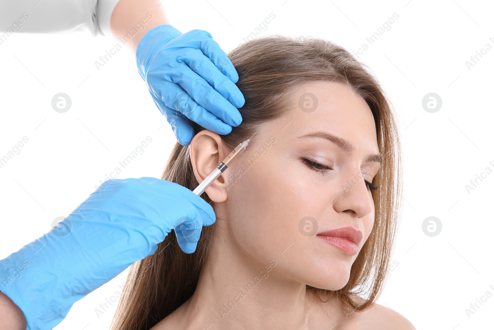 Photo of Young woman with hair loss problem receiving injection on white background