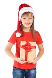Photo of Cute little child in Santa hat with Christmas gift on white background
