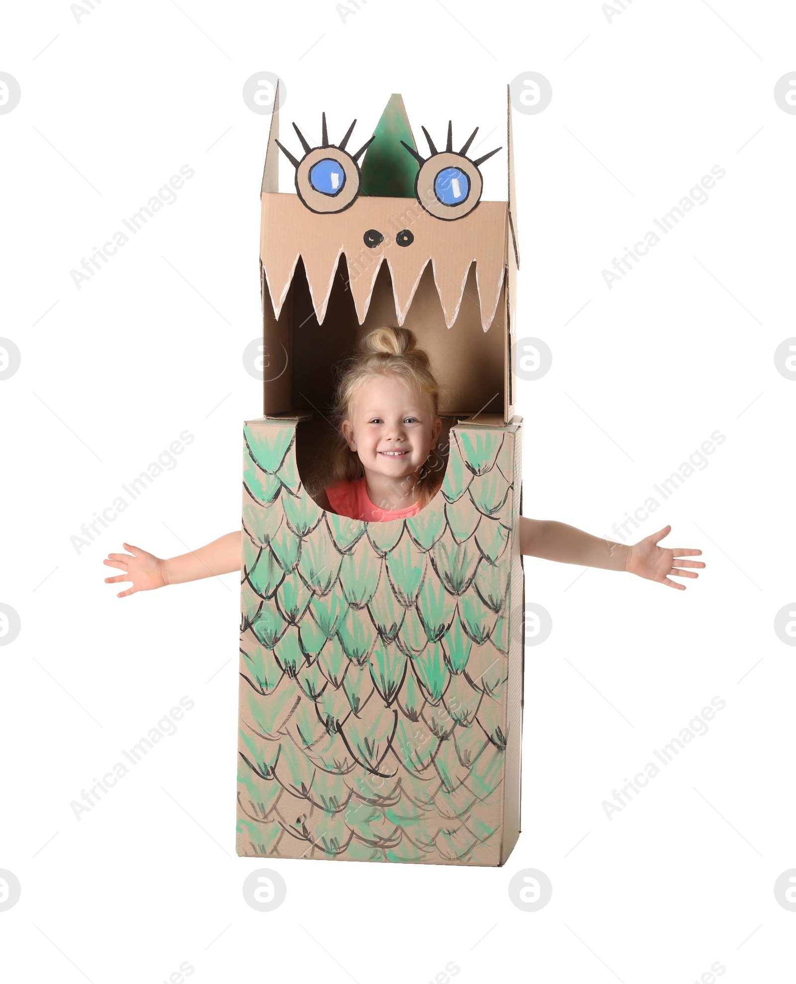 Photo of Cute little girl playing with cardboard dragon on white background