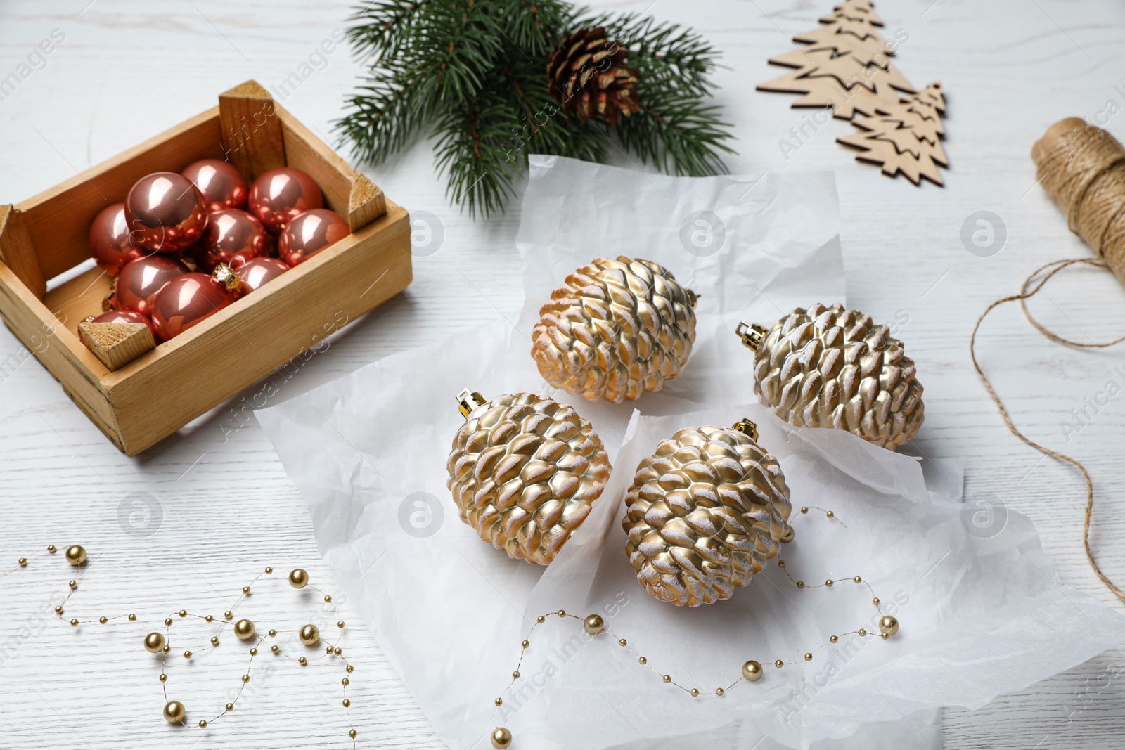 Photo of Composition with beautiful Christmas baubles on white wooden table