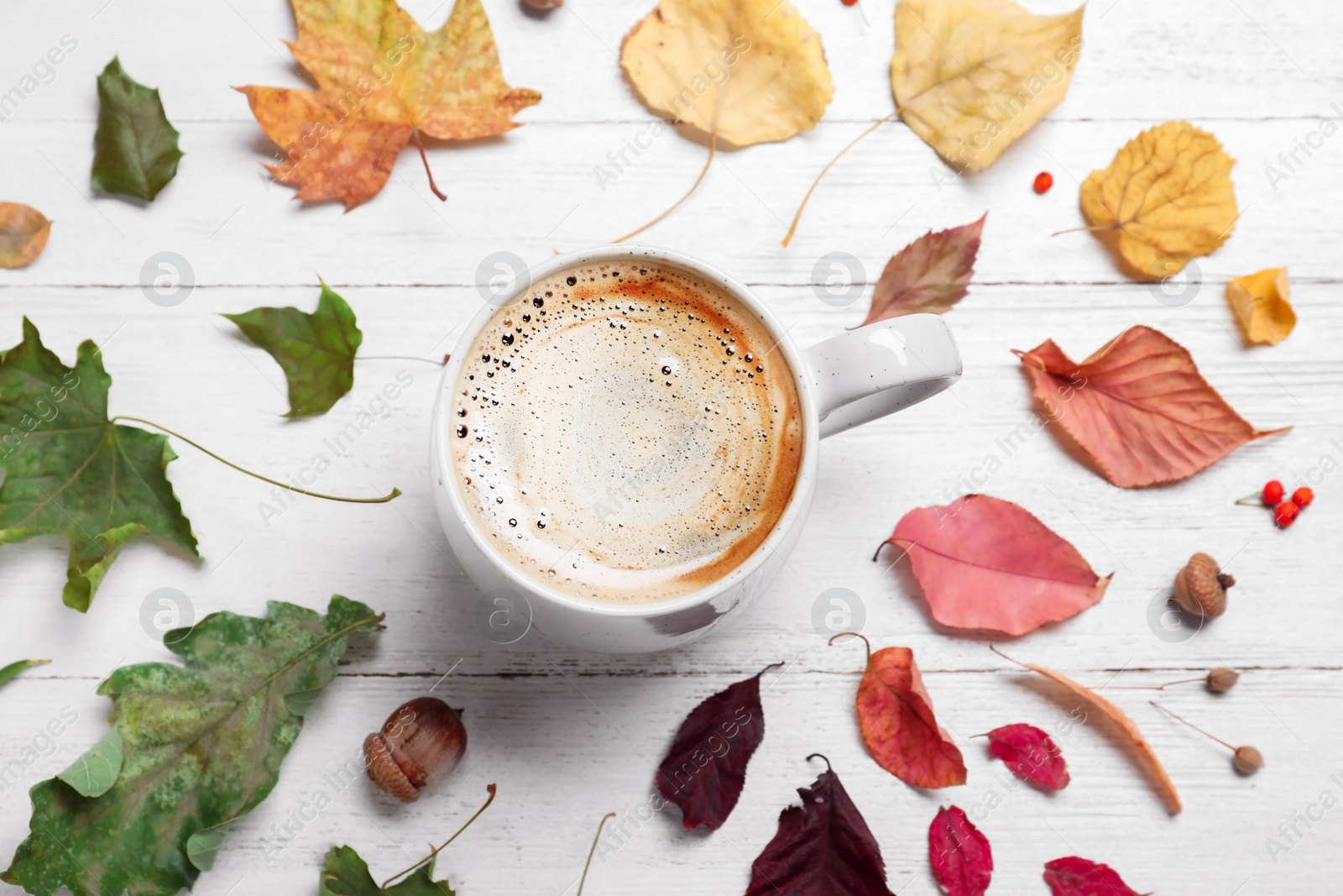 Photo of Flat lay composition with cup of hot drink on white wooden table. Cozy autumn atmosphere