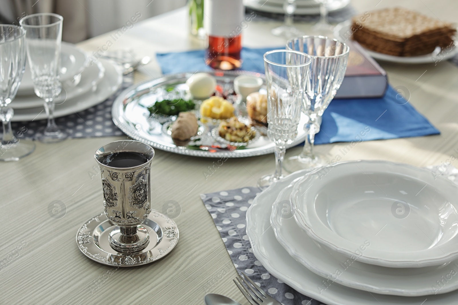 Photo of Antique goblet and plates on table served for Passover (Pesach) Seder