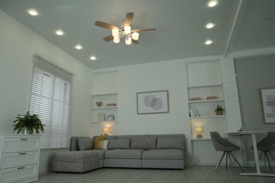 Ceiling fan, furniture and accessories in stylish living room, low angle view