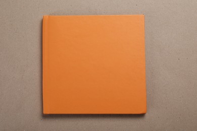 Photo of One photo album on color background, top view