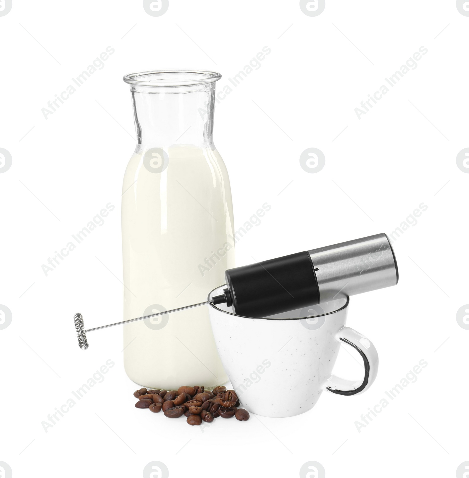 Photo of Mini mixer (milk frother), cup, coffee beans and bottle isolated on white