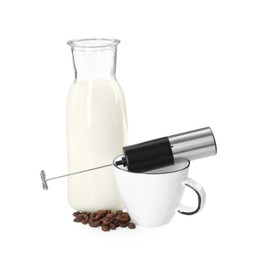 Photo of Mini mixer (milk frother), cup, coffee beans and bottle isolated on white