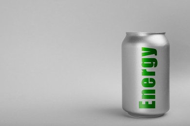 Can of energy drink on light grey background. Space for text