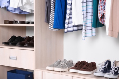 Photo of Wardrobe shelves with different stylish shoes