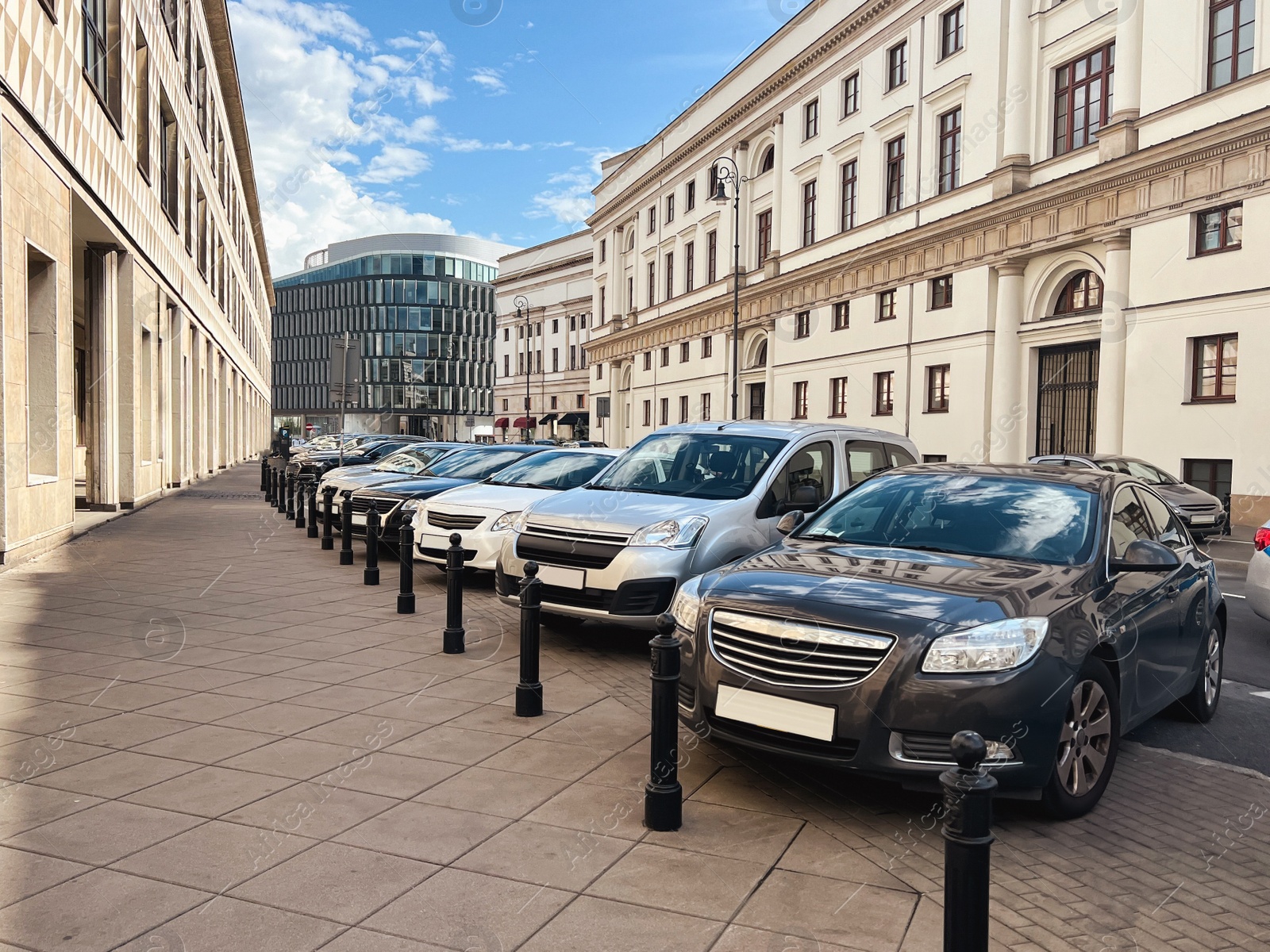 Photo of Different modern cars parked on city street