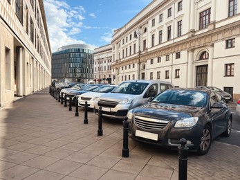 Different modern cars parked on city street