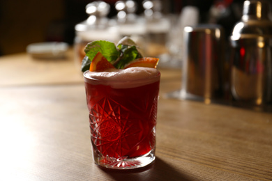 Photo of Glass of fresh alcoholic cocktail on bar counter