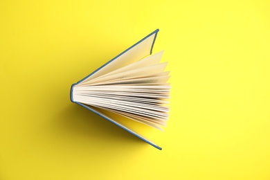 Photo of Hardcover book on yellow background, top view