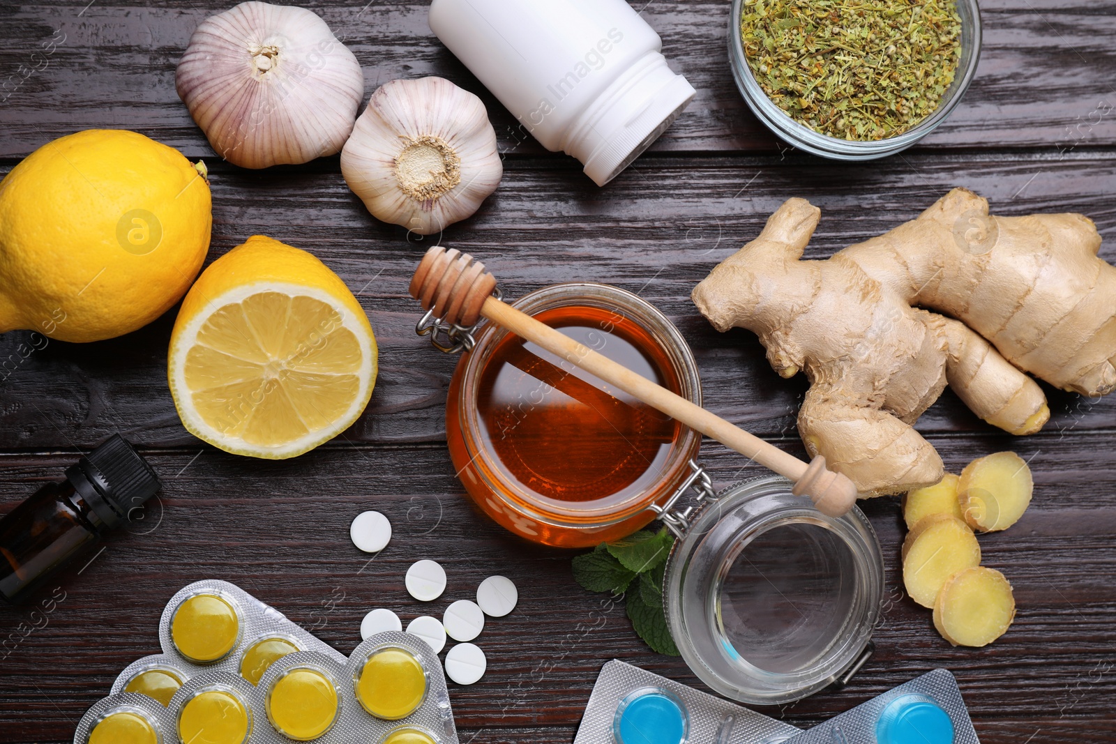 Photo of Different cold remedies on wooden table, flat lay. Cough treatment