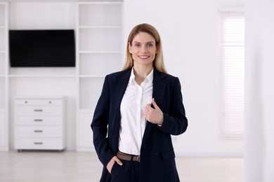 Photo of Happy real estate agent in new house