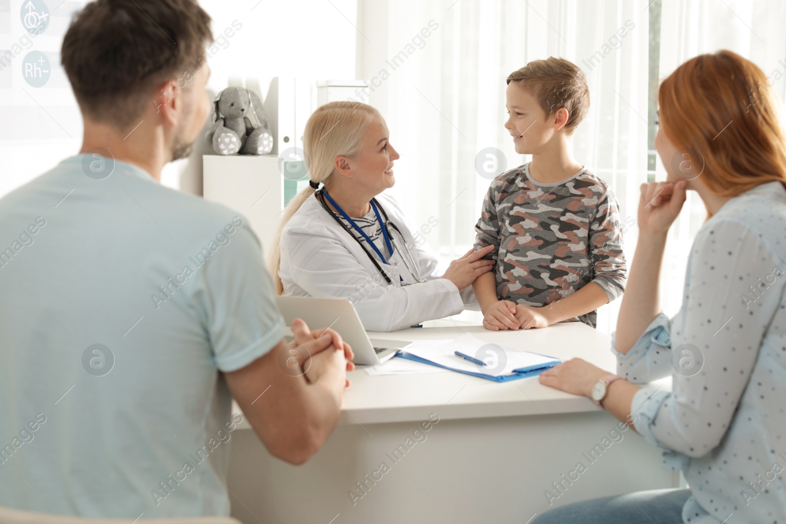 Photo of Family with child visiting doctor in hospital