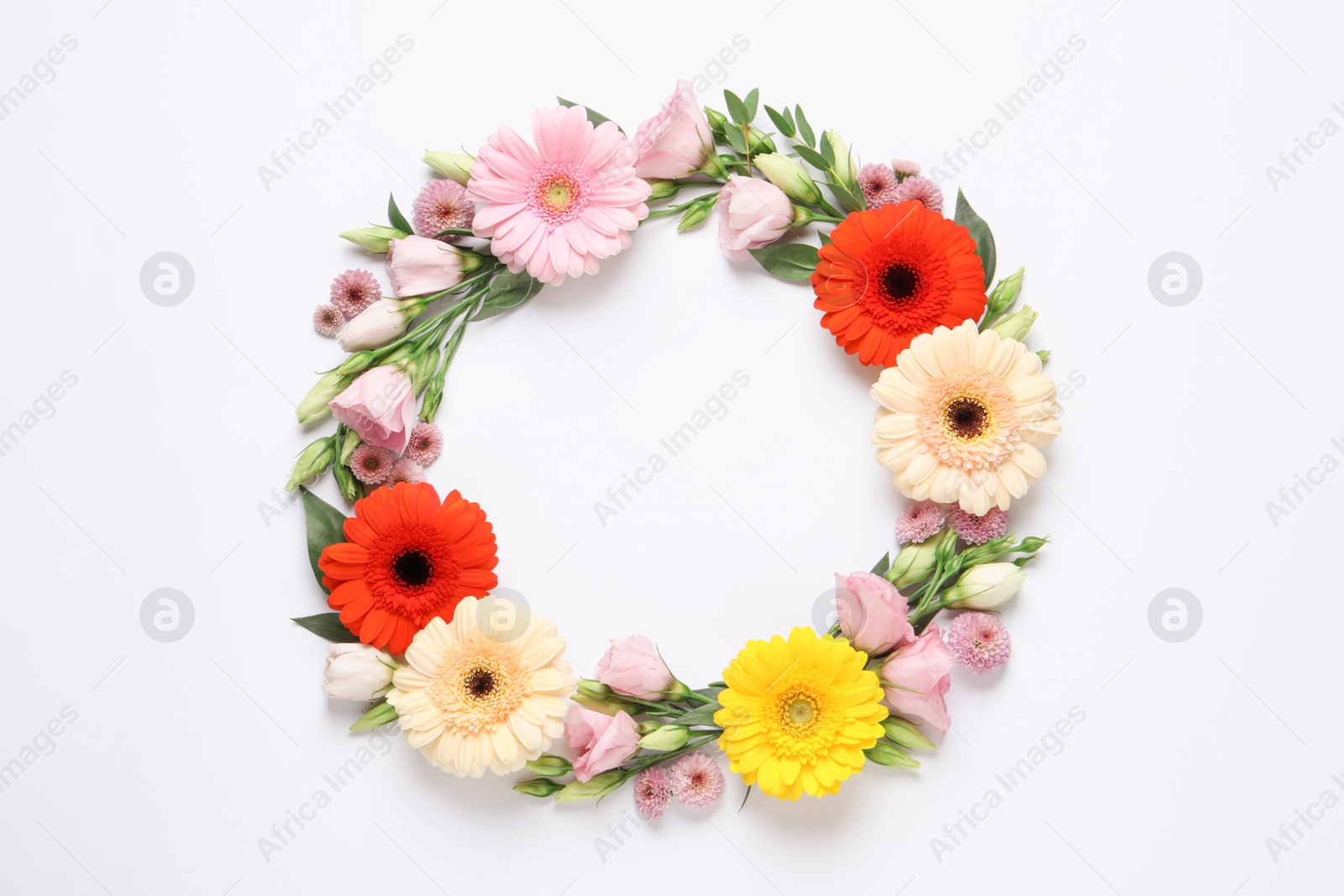 Photo of Wreath made of beautiful flowers and green leaves on white background, flat lay. Space for text