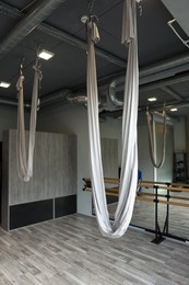 Photo of White hammocks for fly yoga in studio
