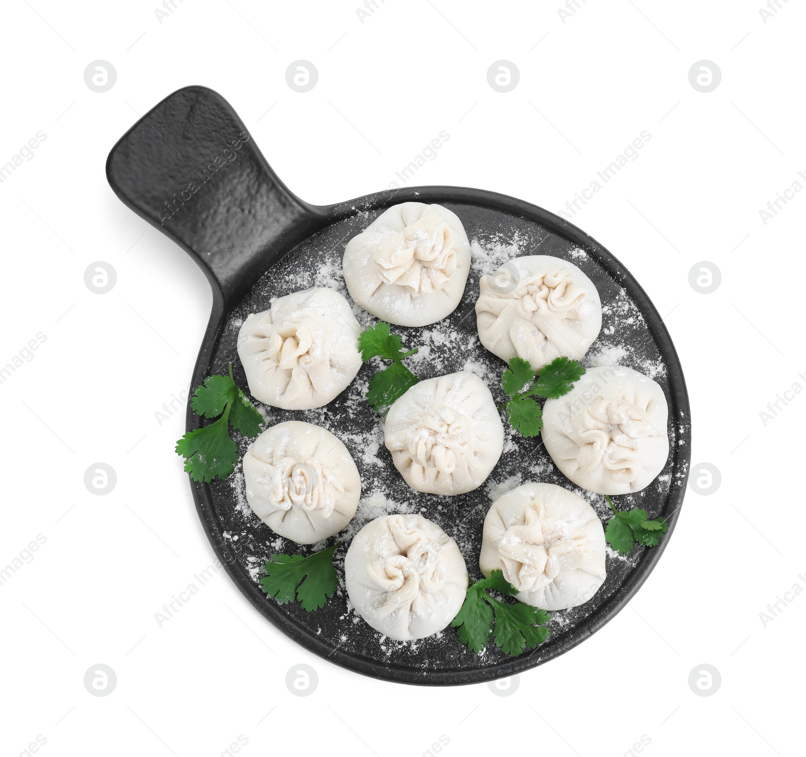 Photo of Board with uncooked khinkali (dumplings) and parsley isolated on white, top view. Georgian cuisine