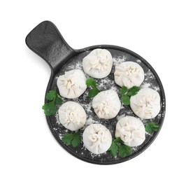 Board with uncooked khinkali (dumplings) and parsley isolated on white, top view. Georgian cuisine