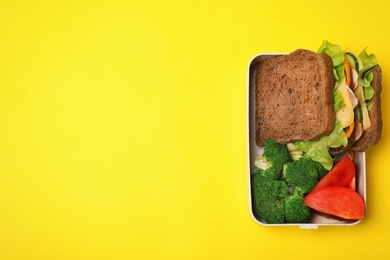 School lunch box of healthy food on color background, top view with space for text