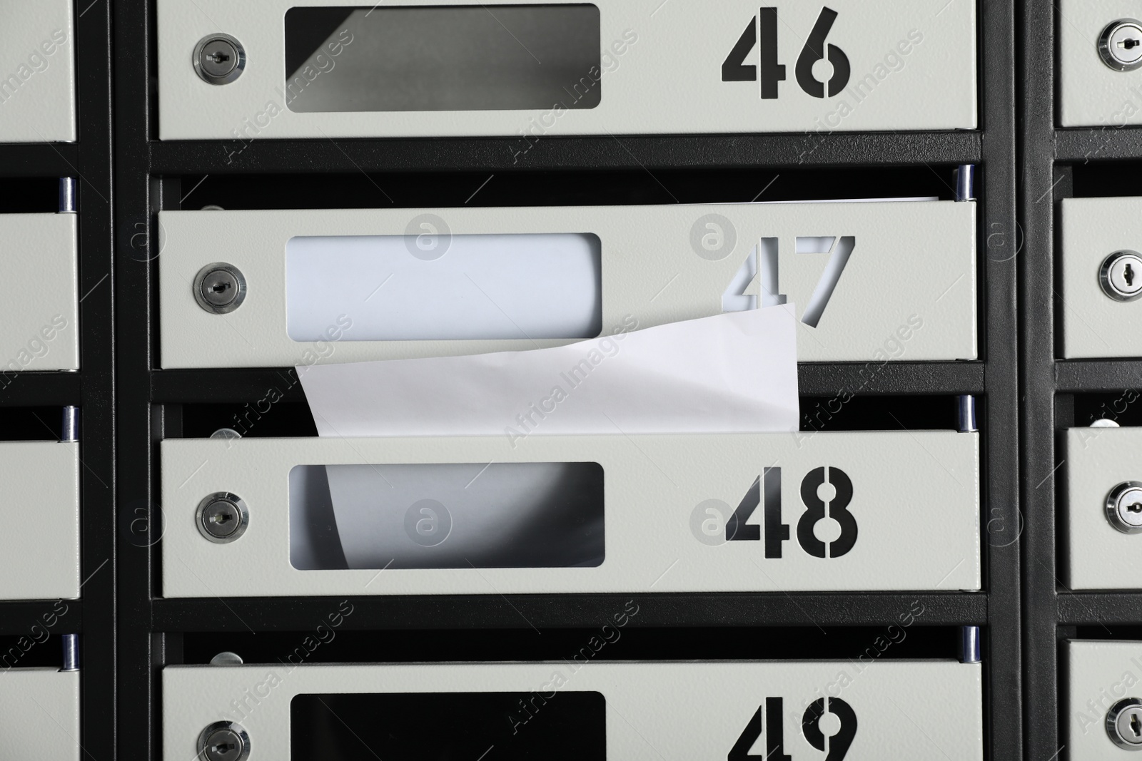 Photo of New mailboxes with keyholes, numbers and receipts as background