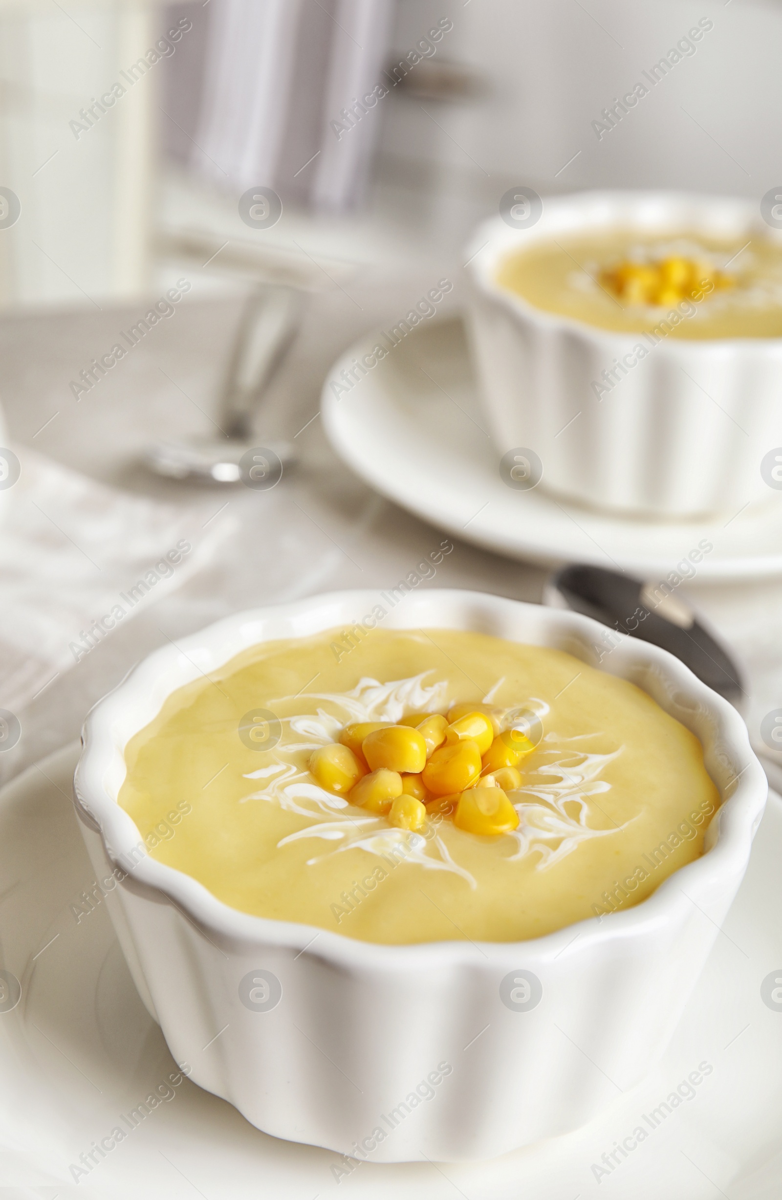 Photo of Delicious corn cream soup served on table