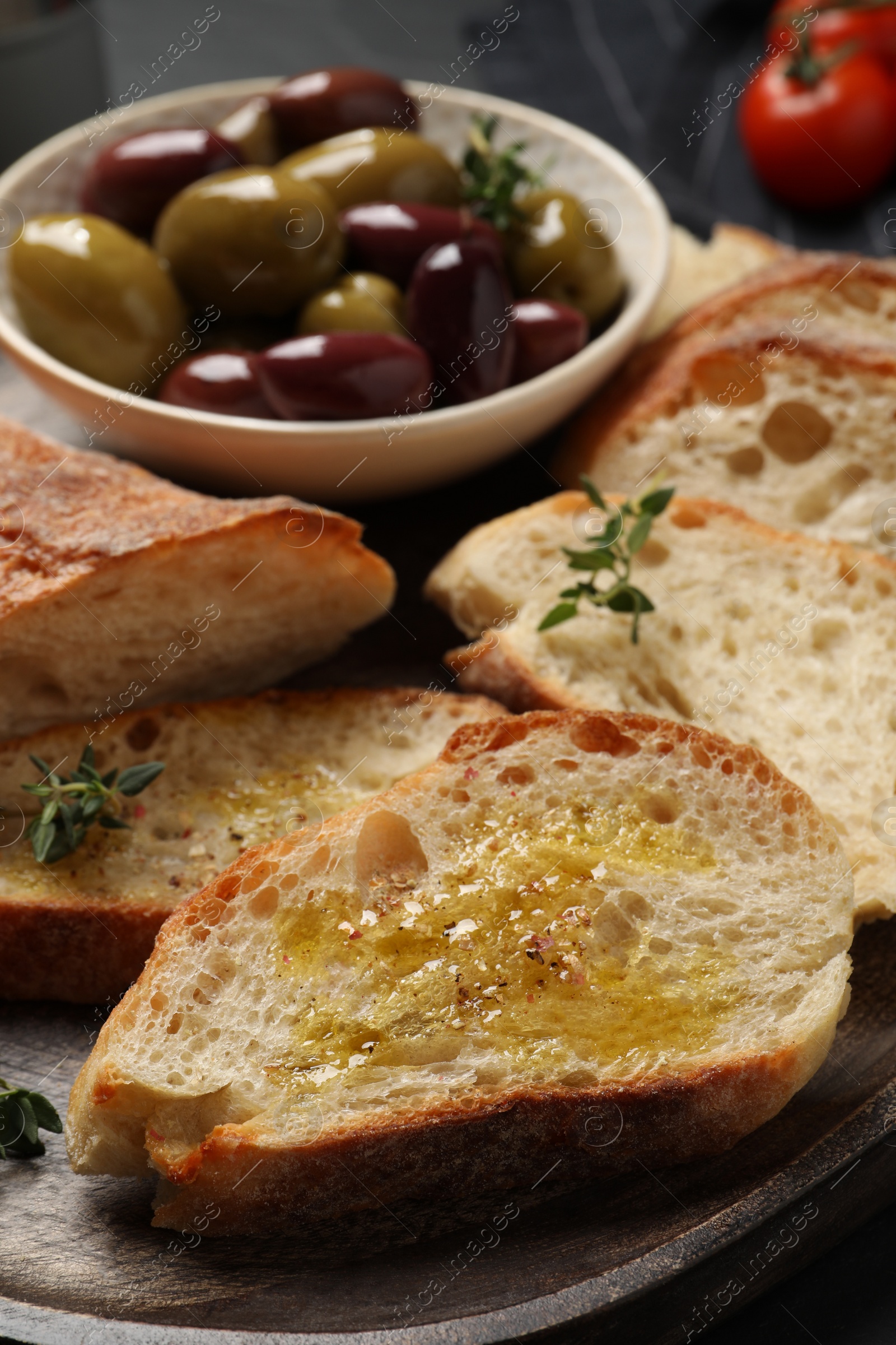 Photo of Tasty bruschettas with oil and thyme on plate, closeup