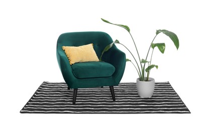 Stylish comfortable armchair with pillow, houseplant and striped rug isolated on white